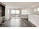 Bright living room with dark wood floors, a bar area, and a sliding door to the balcony at 6068 Beeler Ct, Denver, CO 80238
