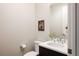 Cozy powder room with elegant fixtures, vanity, and modern finishes at 6068 Beeler Ct, Denver, CO 80238