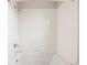 Detailed view of a shower with white tiled walls, chrome fixtures, and a built-in soap dish at 6068 Beeler Ct, Denver, CO 80238