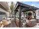 Cozy backyard patio with a fireplace, seating area, and pergola at 11765 Perry St, Westminster, CO 80031