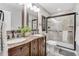 Basement bathroom with granite-top double vanity and a large shower at 11765 Perry St, Westminster, CO 80031