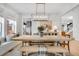 Bright dining room with a farmhouse table and built-in window seat at 11765 Perry St, Westminster, CO 80031