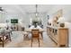 Elegant dining room with a large wooden table and stylish light fixture at 11765 Perry St, Westminster, CO 80031