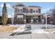 Two-story craftsman home with gray siding, stone accents, and a welcoming front porch at 11765 Perry St, Westminster, CO 80031