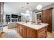 Modern kitchen island with quartz countertop and wood cabinets at 11765 Perry St, Westminster, CO 80031