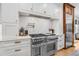 Luxury kitchen with stainless steel appliances and white cabinetry at 11765 Perry St, Westminster, CO 80031