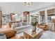 Open living room with wood coffee table and leather armchairs at 11765 Perry St, Westminster, CO 80031