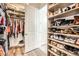 Walk-in closet with custom shelving for shoes, clothes, and accessories at 15747 Willow Way, Thornton, CO 80602