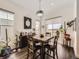 Bright dining room with large windows, stylish light fixture, hardwood floors, and comfortable seating at 15747 Willow Way, Thornton, CO 80602