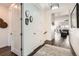 Inviting entryway featuring dark wood floors and a glimpse of the adjacent living spaces at 15747 Willow Way, Thornton, CO 80602