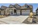 Lovely home with stone accents, a covered porch, a two-car garage and a large driveway at 15747 Willow Way, Thornton, CO 80602