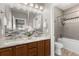 Bathroom featuring a double vanity, granite countertops and a bathtub with shower at 12935 Lafayette St # B, Thornton, CO 80241