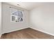 Empty bedroom with wood floors and large window at 12935 Lafayette St # B, Thornton, CO 80241
