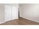 Bedroom featuring wood floors and a closet with sliding doors at 12935 Lafayette St # B, Thornton, CO 80241