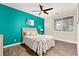Comfortable bedroom with a bright accent wall and natural light at 12935 Lafayette St # B, Thornton, CO 80241