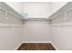 An empty closet with white shelving and wood floors at 12935 Lafayette St # B, Thornton, CO 80241
