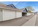 Exterior garages with blue siding and white doors at 12935 Lafayette St # B, Thornton, CO 80241