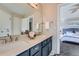 Bathroom featuring double sinks, ample counter space, and access to the main bedroom at 8791 Troon Village Pl, Lone Tree, CO 80124