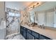 Modern bathroom features a double vanity, marble accents, and a glass-enclosed shower at 8791 Troon Village Pl, Lone Tree, CO 80124