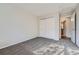 Bedroom with neutral walls, gray carpet, closet, and a glimpse into the bathroom at 8791 Troon Village Pl, Lone Tree, CO 80124