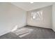 Cozy bedroom with gray carpet and a window providing natural light at 8791 Troon Village Pl, Lone Tree, CO 80124