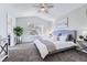 Inviting bedroom with a large window, ceiling fan, and comfortable furnishings at 8791 Troon Village Pl, Lone Tree, CO 80124