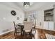 Dining room features a round table, upholstered chairs, and modern light fixture at 8791 Troon Village Pl, Lone Tree, CO 80124