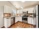 Well-lit kitchen with stainless steel appliances, tile backsplash, and ample cabinet space at 8791 Troon Village Pl, Lone Tree, CO 80124