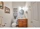 Charming powder room with decorative seashell-themed art and a vessel sink, accented with white walls at 1851 Ute Creek Dr, Longmont, CO 80504