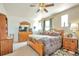 Inviting bedroom with a wooden dresser, natural light, and ceiling fan for added comfort at 1851 Ute Creek Dr, Longmont, CO 80504