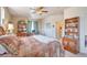 Comfortable bedroom featuring a ceiling fan, bookshelf, and desk area for work or study at 1851 Ute Creek Dr, Longmont, CO 80504