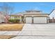 Charming home featuring a well-maintained lawn, a spacious driveway and three-car garage at 1851 Ute Creek Dr, Longmont, CO 80504