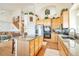 Open kitchen with center island, stainless appliances, and staircase leading to the upper level at 1851 Ute Creek Dr, Longmont, CO 80504