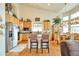 Bright kitchen featuring granite countertops, stainless appliances, a center island and adjacent breakfast nook at 1851 Ute Creek Dr, Longmont, CO 80504