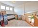Upstairs living area featuring plush carpeting, a comfortable couch, and bright windows at 1851 Ute Creek Dr, Longmont, CO 80504