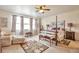 Spacious main bedroom featuring a four-poster bed, ceiling fan, sitting area, and natural light at 1851 Ute Creek Dr, Longmont, CO 80504