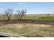 Wide-open backyard view with distant trees and open fields and a fence in the foreground at 1965 S Coolidge Way, Aurora, CO 80018