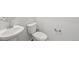Clean bathroom featuring a pedestal sink, toilet, and chrome fixtures at 1965 S Coolidge Way, Aurora, CO 80018
