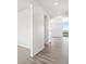 Inviting entryway with hardwood floors leading to a bright living area with a sliding glass door and balcony at 1965 S Coolidge Way, Aurora, CO 80018