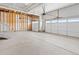 Unfinished two car garage featuring concrete floors and room for car parking and storage at 1965 S Coolidge Way, Aurora, CO 80018