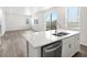 Bright kitchen features stainless steel appliances, white cabinets, white countertops, and wood flooring at 1965 S Coolidge Way, Aurora, CO 80018