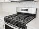 Bright kitchen features stainless steel appliances, white cabinets, and white countertops at 1965 S Coolidge Way, Aurora, CO 80018