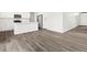 Bright kitchen features stainless steel appliances, white cabinets, white countertops, and wood flooring at 1965 S Coolidge Way, Aurora, CO 80018