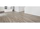 Open-concept living room with wood floors and modern kitchen at 1965 S Coolidge Way, Aurora, CO 80018