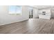Open-concept living room with wood floors, large windows, and a view of the kitchen at 1965 S Coolidge Way, Aurora, CO 80018