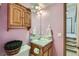 Bathroom featuring a wooden cabinet, mirror, and sink at 4933 Altura St, Denver, CO 80239