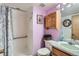 Bathroom featuring a shower, a wooden cabinet, and a mirror at 4933 Altura St, Denver, CO 80239