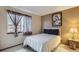 Cozy bedroom featuring a bright window, white comforter, and neutral paint at 4933 Altura St, Denver, CO 80239