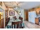 Bright dining area with wooden table set, laminate flooring, and oak cabinets for convenient storage at 4933 Altura St, Denver, CO 80239