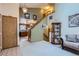 Inviting entryway showcasing open staircase, stylish decor, and seamlessly connecting to the kitchen area at 4933 Altura St, Denver, CO 80239